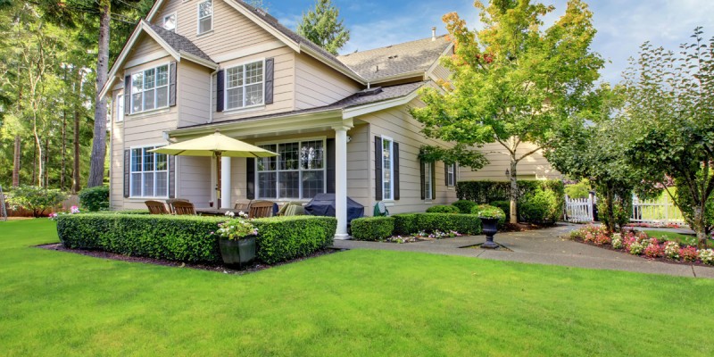 Large beige house with green grass